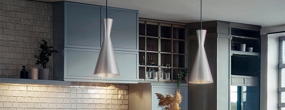 Three black pendant lights installed over a kitchen bench